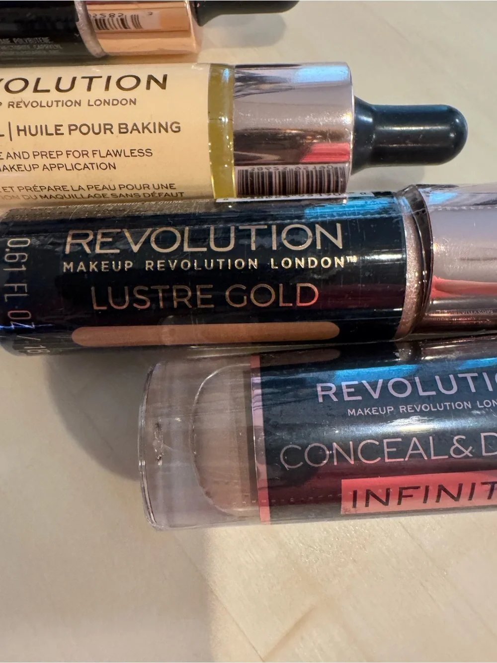 Revolution Concealer, Liquid Highlighters, and Baking Oil. All 4 included. NWT